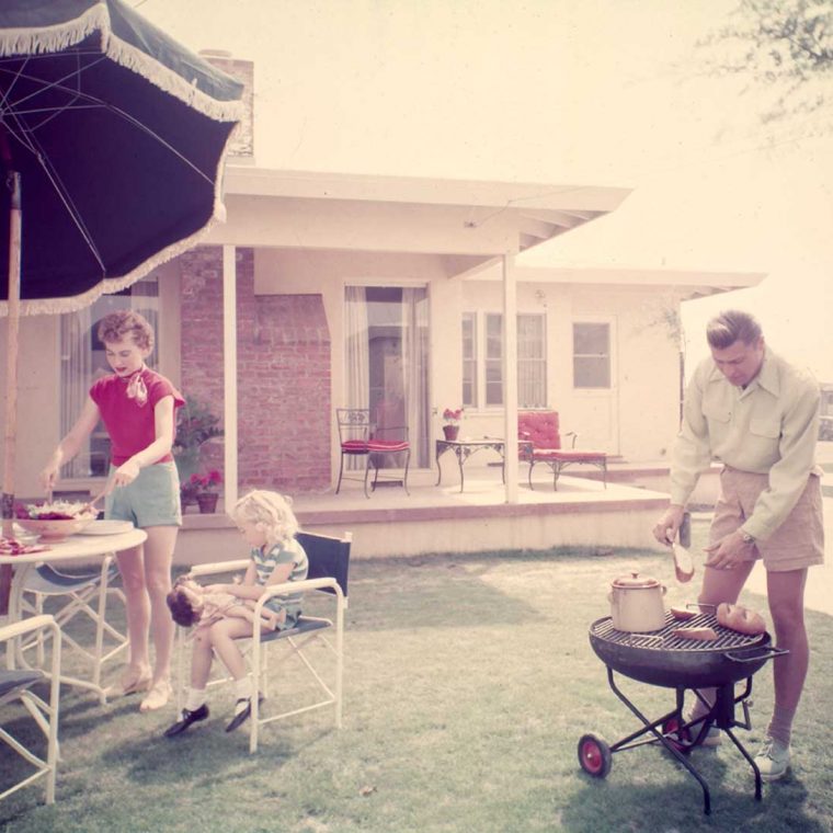 Family barbecue in Lakewood Plaza suburban development, Long Beach, California, ca. 1950. Architect: Chris Choate with designer Cliff May. Photo by Maynard L. Parker; The Huntington Library, San Marino, California. 