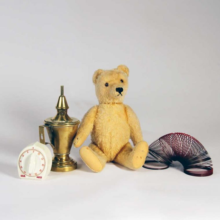 Kitchen timer, 1990s (Sally D. Liff); Whale oil lamp, c. 1810s; Teddy bear, 1930s (Cynthia Field); Slinky, 1960s. Photo by Museum staff. 