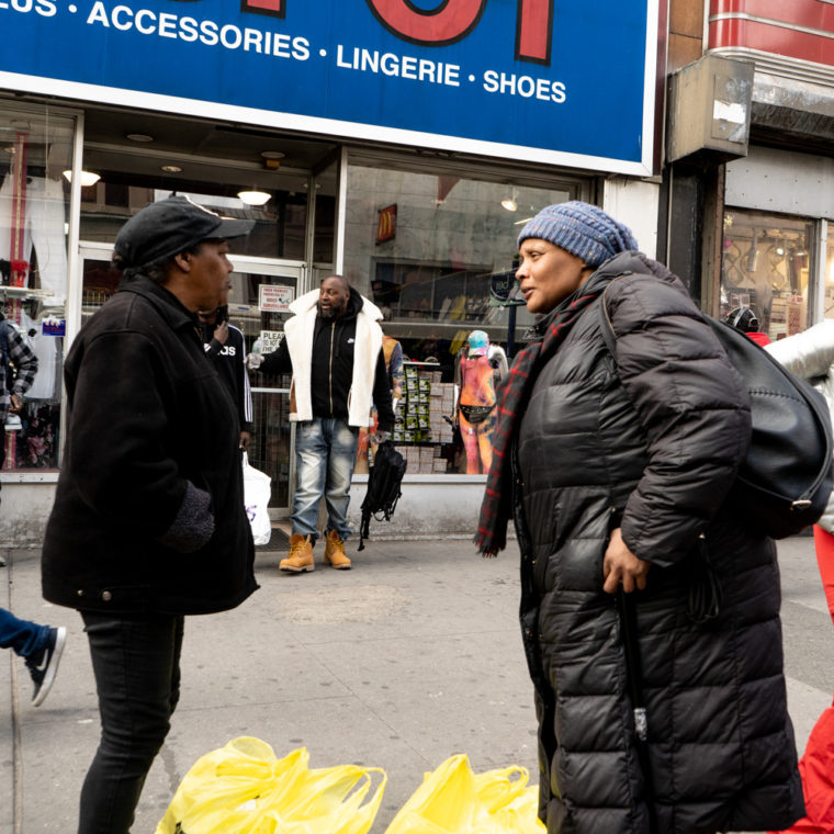 March 16, 2020: Waiting for the bus at the intersection of Market and Broad Streets, Four Corners, Newark, New Jersey. © Camilo José Vergara 