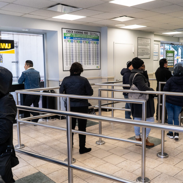 March 22, 2020: Inside a busy PLS Check Cashing store on Roosevelt Avenue at Junction Boulevard, Queens, New York. © Camilo José Vergara 