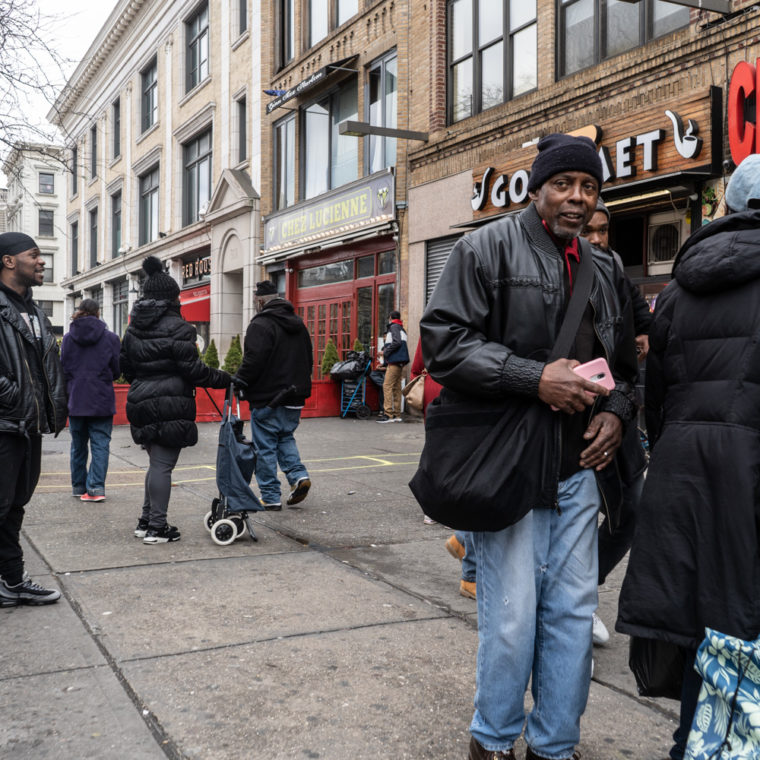 April 4, 2020: Waiting in line outside CFSC Checks Cashed, 302 Malcolm X Boulevard, Harlem, New York, New York. © Camilo José Vergara 