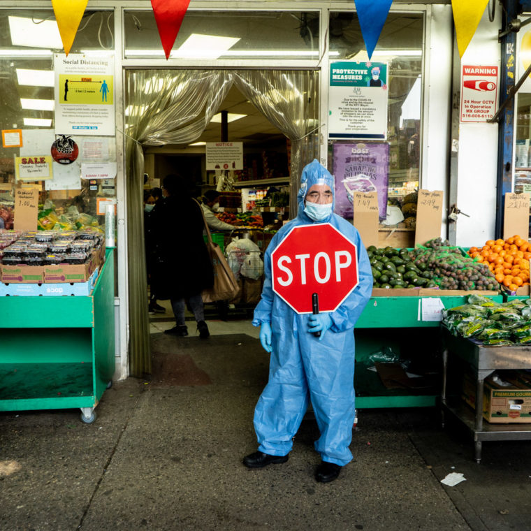 April 25, 2020: José, wearing protective gear and controlling entry to the H F Dollar & Up Fruits & Vegetables store, 61-27 Roosevelt Avenue, Queens, New York. © Camilo José Vergara 