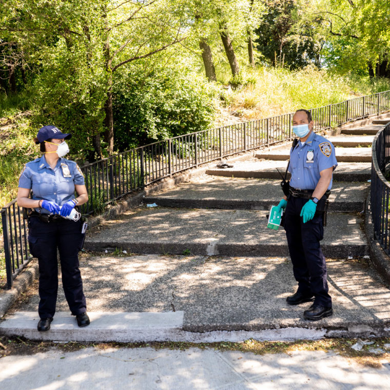 May 31, 2020: New York City police officers distributing masks and gloves to people entering Claremont Park, Teller Avenue at East 170th Street, Bronx, New York. © Camilo José Vergara 