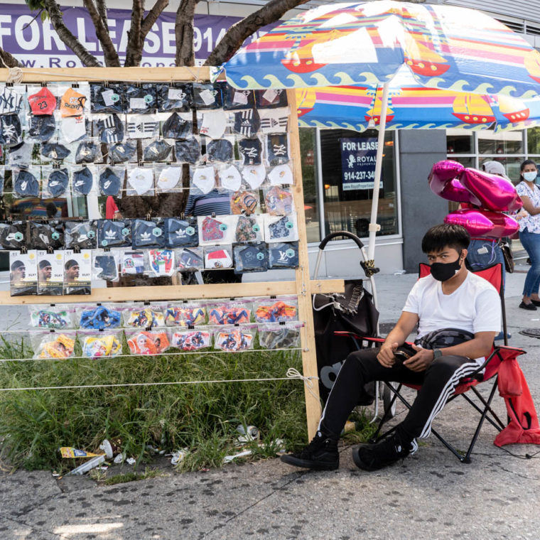 August 17, 2020: Teenager selling masks. 928 Hunts Point Avenue, Bronx, New York. © Camilo José Vergara 