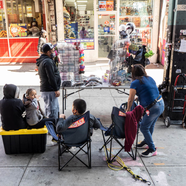 September 21, 2020: Street vendors and their children selling PPE and articles of clothing. 2278 Jerome Avenue, Bronx, New York. © Camilo José Vergara 