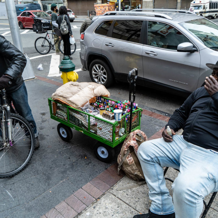 October 23, 2020: The $100 cart from Home Depot is “movable,” the oil and African soap vendor in the picture told me. Market Street at Halsey Street, Newark, New Jersey. © Camilo José Vergara 