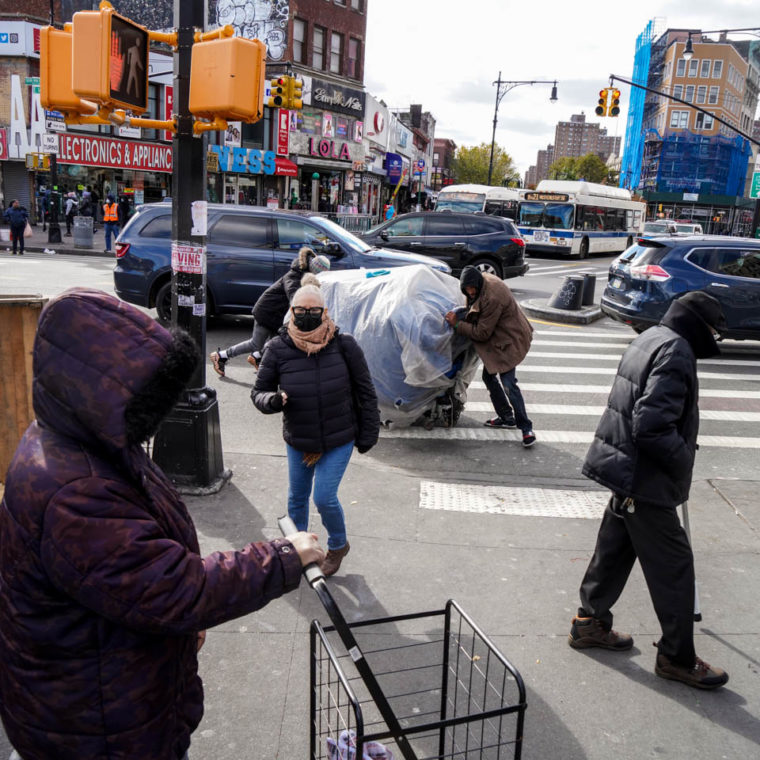 November 2, 2020: Street vendors setting up shop. East 149th Street at Third Avenue, Bronx, New York. © Camilo José Vergara 