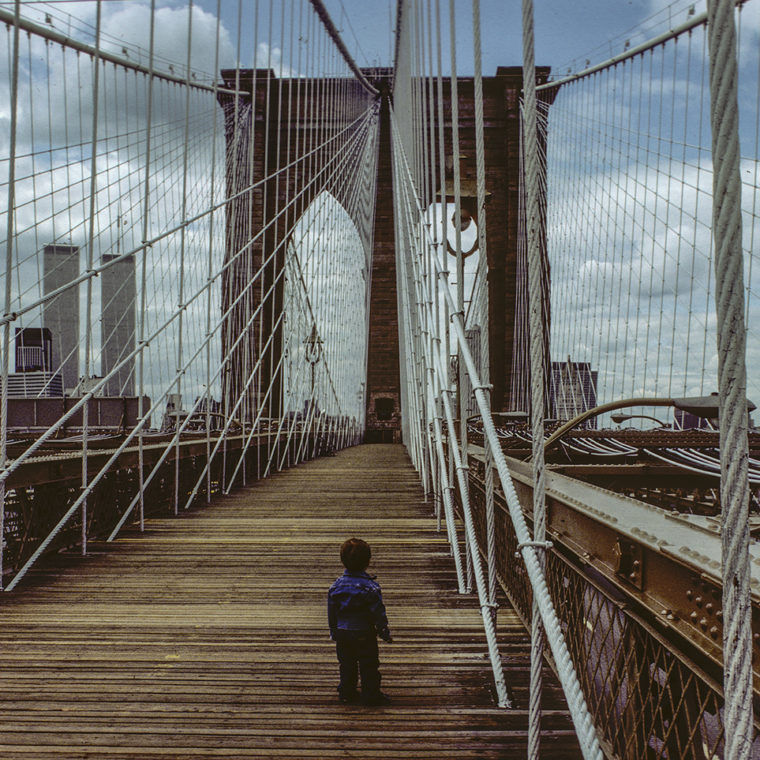 View west from the Brooklyn Bridge with Charlie, Brooklyn, New York; 1983. 